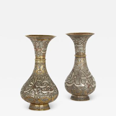 A pair of brass Syrian Mamluk revival vases with silver and copper inlay