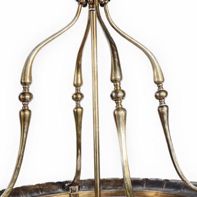 A pair of brass drum lanterns in the style of Lutyens