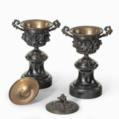 A pair of bronze vases and covers in the classical style