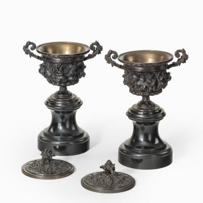 A pair of bronze vases and covers in the classical style