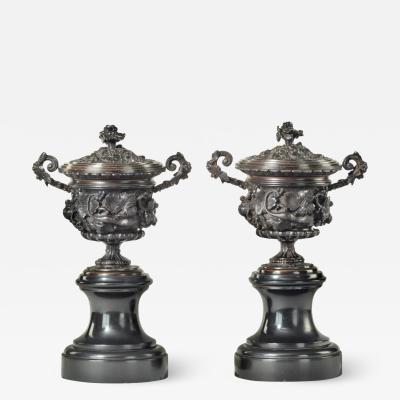 A pair of bronze vases and covers in the classical style