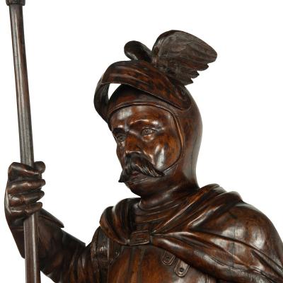 A pair of carved walnut mediaeval knights