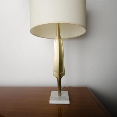 A pair of contemporary brass lamps on square marble bases