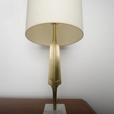 A pair of contemporary brass lamps on square marble bases