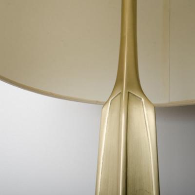 A pair of contemporary brass lamps on square marble bases