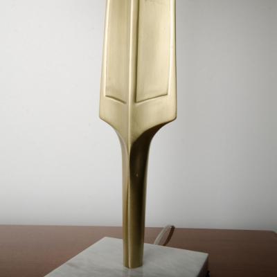 A pair of contemporary brass lamps on square marble bases