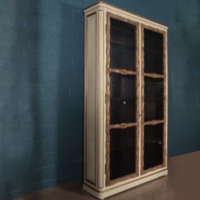 A pair of cream painted and parcel gilt large bookcases French 19th C