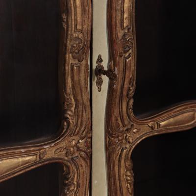 A pair of cream painted and parcel gilt large bookcases French 19th C