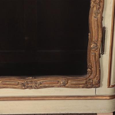 A pair of cream painted and parcel gilt large bookcases French 19th C