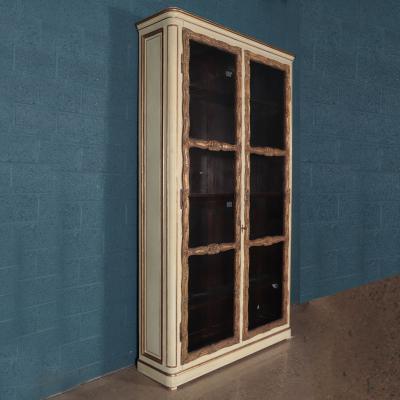 A pair of cream painted and parcel gilt large bookcases French 19th C