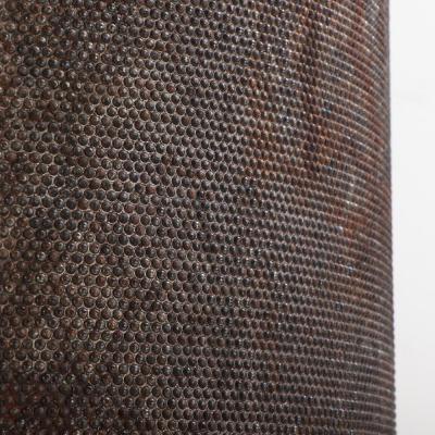 A pair of dimpled iron industrial tubes fitted as lamps