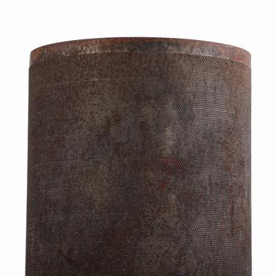 A pair of dimpled iron industrial tubes fitted as lamps