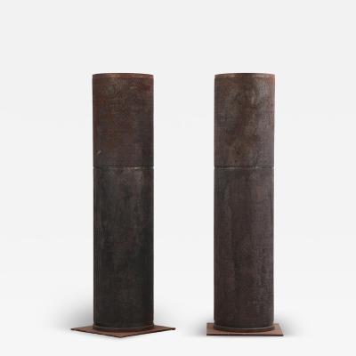 A pair of dimpled iron industrial tubes fitted as lamps 