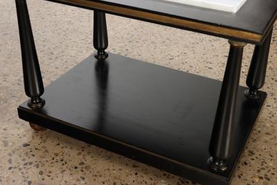 A pair of ebonized and gilt marble top end tables on ball feet circa 1950 