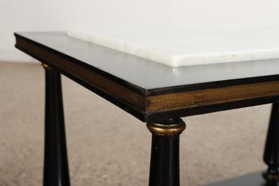 A pair of ebonized and gilt marble top end tables on ball feet circa 1950 