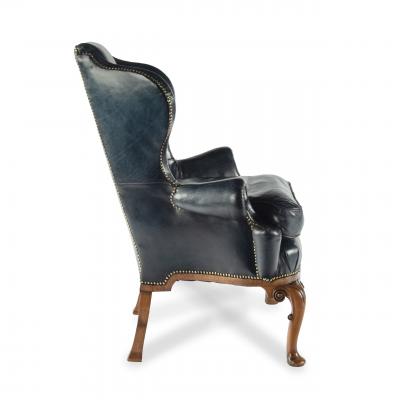 A pair of generous George I style walnut wing arm chairs