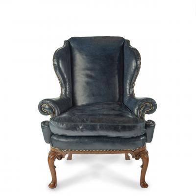 A pair of generous George I style walnut wing arm chairs