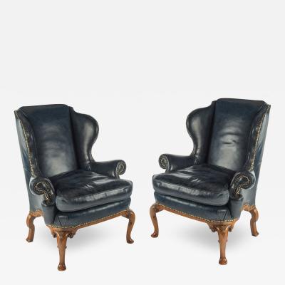 A pair of generous George I style walnut wing arm chairs