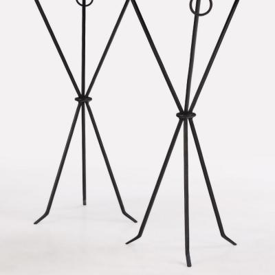 A pair of iron and mahogany drinks tables in the manner of Jean Michel Frank 