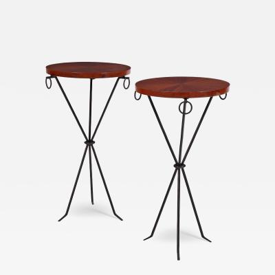 A pair of iron and mahogany drinks tables in the manner of Jean Michel Frank 