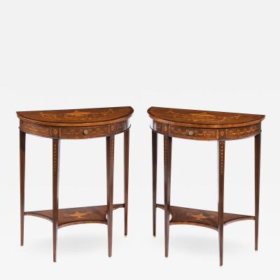 A pair of late Victorian demi lune mahogany console tables