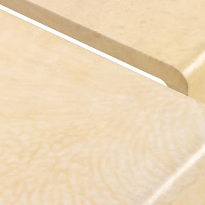 A pair of nesting parchment coffee tables in the manner of Jean Michel Frank 