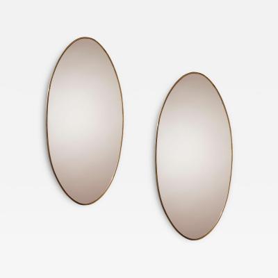 A pair of oval brass mirrors Italy 1960s