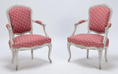 A pair of painted and carved French Louis XV style open arm chairs circa 1900 
