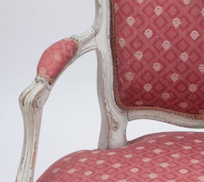 A pair of painted and carved French Louis XV style open arm chairs circa 1900 