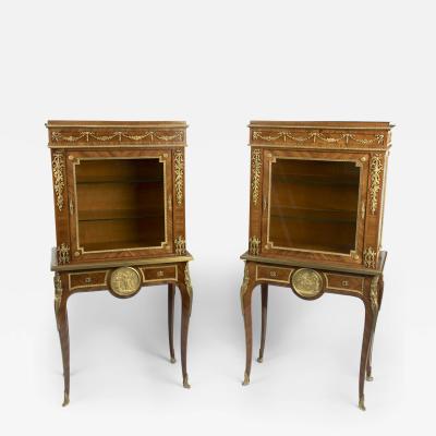 A pair of small Napoleon III kingwood display cabinets on stands