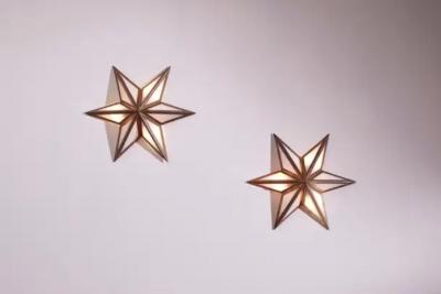 A pair of star shaped wall sconces made of brass and glass Italy 1960s