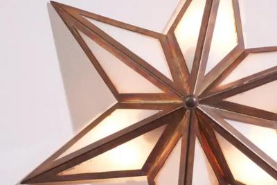 A pair of star shaped wall sconces made of brass and glass Italy 1960s