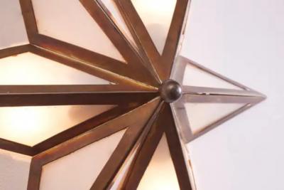 A pair of star shaped wall sconces made of brass and glass Italy 1960s