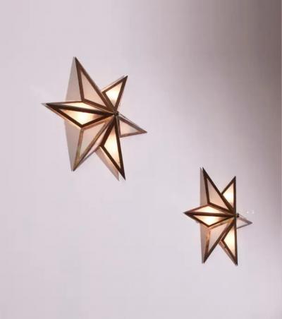 A pair of star shaped wall sconces made of brass and glass Italy 1960s