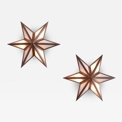 A pair of star shaped wall sconces made of brass and glass Italy 1960s