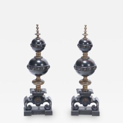 A pair of two tone brass andirons in the Renaisance style 