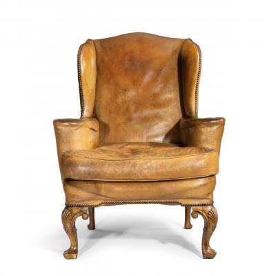 A pair of walnut wing armchairs in the Queen Anne style
