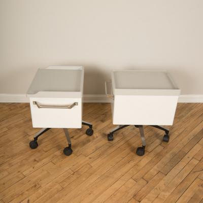 A pair of white and blue two drawers side cabinets on rolling base 1970s
