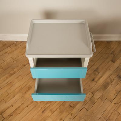 A pair of white and blue two drawers side cabinets on rolling base 1970s