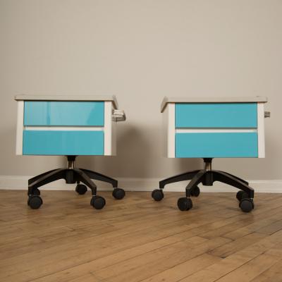 A pair of white and blue two drawers side cabinets on rolling base 1970s