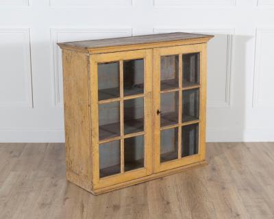 A period gustavian wall cabinet with glossed doors scraped to original paint