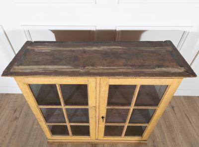 A period gustavian wall cabinet with glossed doors scraped to original paint