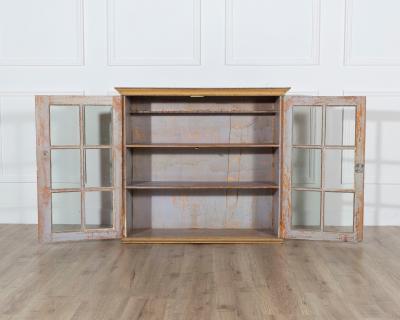 A period gustavian wall cabinet with glossed doors scraped to original paint