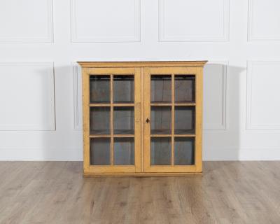 A period gustavian wall cabinet with glossed doors scraped to original paint