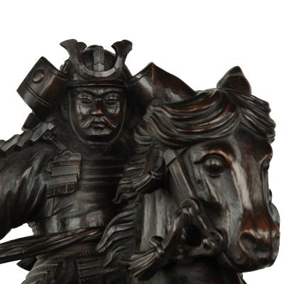 A powerful Japanese equestrian wood carving of a samurai by Yoshida Issen Isshun