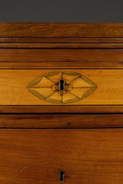 A rare pair of Frederick VI mahogany and satinwood inlaid demi lune commodes