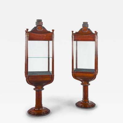 A rare pair of mahogany revolving nautically themed display cabinets