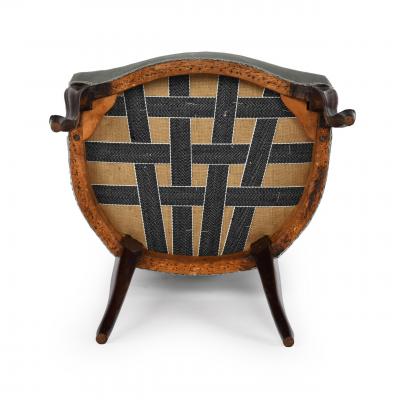 A rare set of twelve George III mahogany open arm chairs in the French Hepplewhi