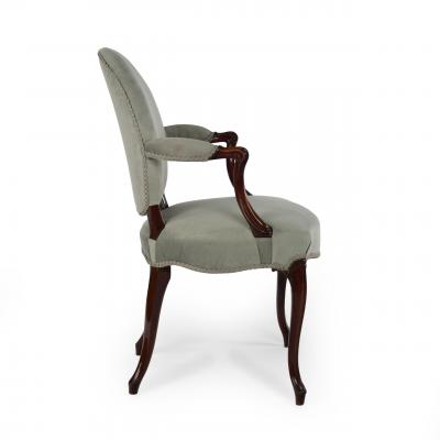 A rare set of twelve George III mahogany open arm chairs in the French Hepplewhi