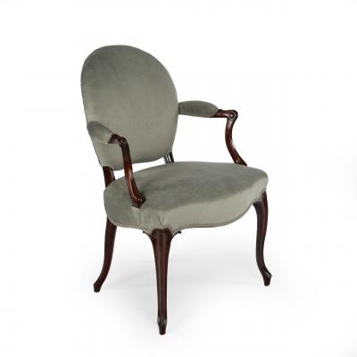 A rare set of twelve George III mahogany open arm chairs in the French Hepplewhi